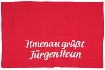 Rotes Banner mit weißer Schriftzug „Ilmenau grüßt Jürgen Heun“