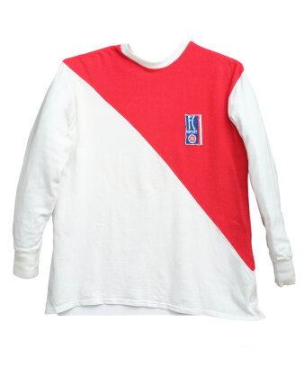 Weißes Langarm-Trikot mit Logo und einem roten Stoffeinsatz von der rechten Schulter bis zur linken Hüfte.
